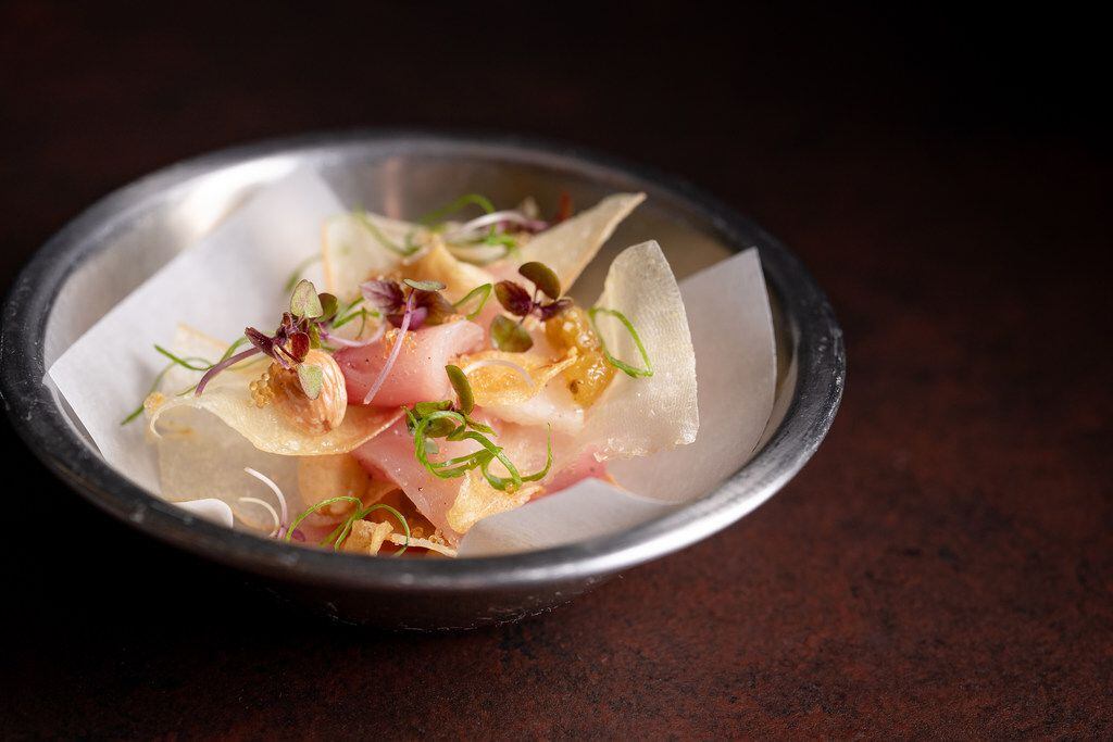 The machi cure at Uchi Dallas includes smoked yellowtail, yuca crisp and Marcona almond.
