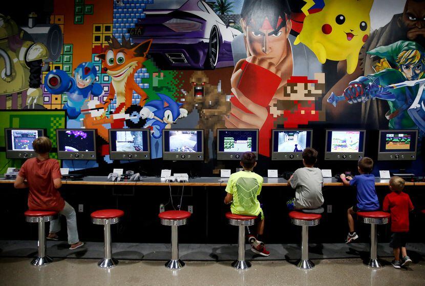 Boys play video games at the National Videogame Museum in Frisco on  Aug. 2, 2018. (Rose...