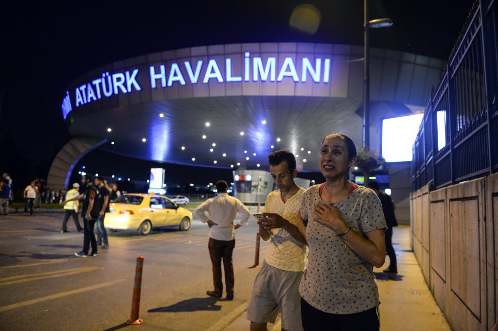 People stood outside Istanbul's Ataturk International Airport, where two explosions killed...