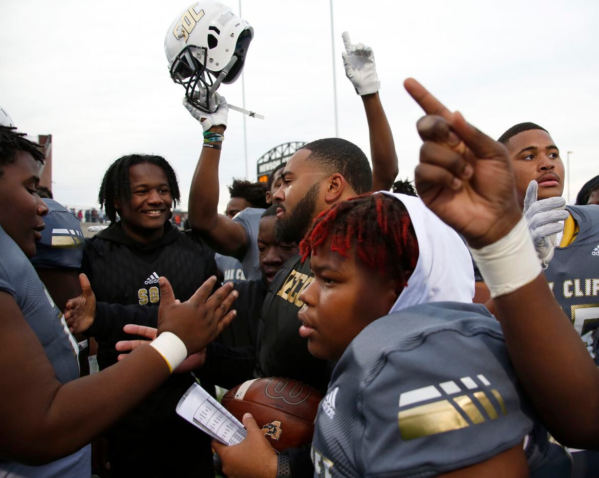 South Oak Cliff assistant coach Dominic Spencer is surrounded by Golden Bears players as they celebrate their 33-28 victory over Aledo to advance. The two teams played their Class 5A Division ll Region ll semifinal football game at Vernon Newsom Stadium in Mansfield on November 26, 2021. (Steve Hamm/ Special Contributor)