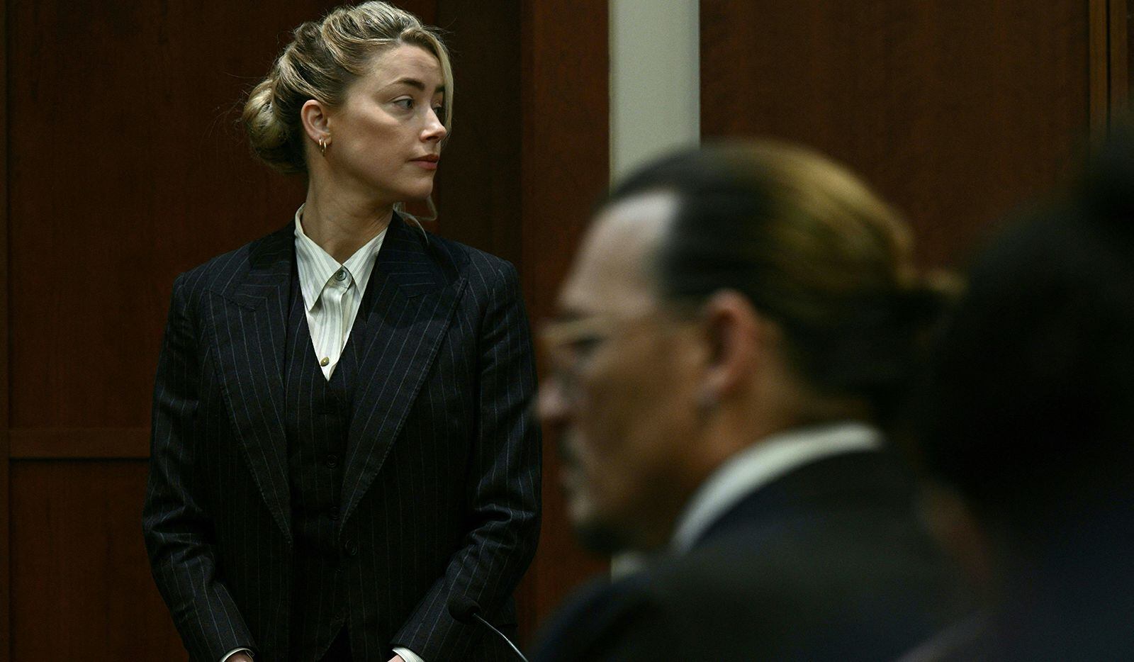 Actors Amber Heard and Johnny Depp watched as the jury came into the courtroom after a lunch...