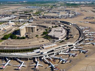 Aerial view of American Airlines aircraft at the gates of Terminal C (bottom) and Terminal A (top) at Dallas Fort Worth (DFW) International Airport on April 16, 2020.