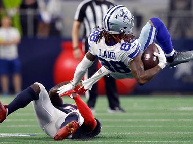 Dallas Cowboys wide receiver CeeDee Lamb (88) is flipped over by Houston Texans cornerback...