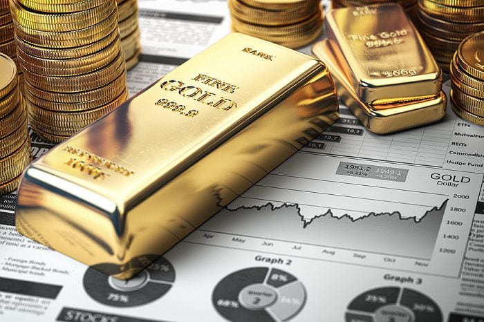 Gold bar, ingots and coins on financial  report. Growth of gold on stock market concept. 3d...
