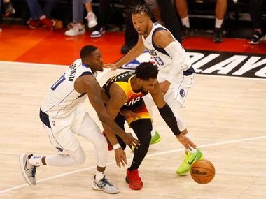 Utah Jazz guard Donovan Mitchell (45) splits Dallas Mavericks forward Dorian Finney-Smith...