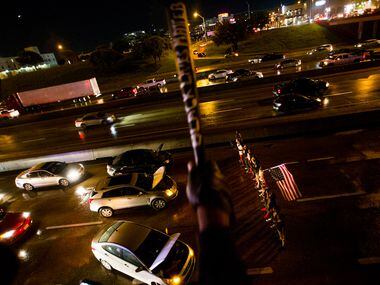 Traffic comes to a standstill on a downtown freeway as protesters demanding an end to police...