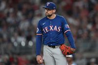 Texas Rangers pitcher Nathan Eovaldi waits on the mound to be relieved in the sixth inning...