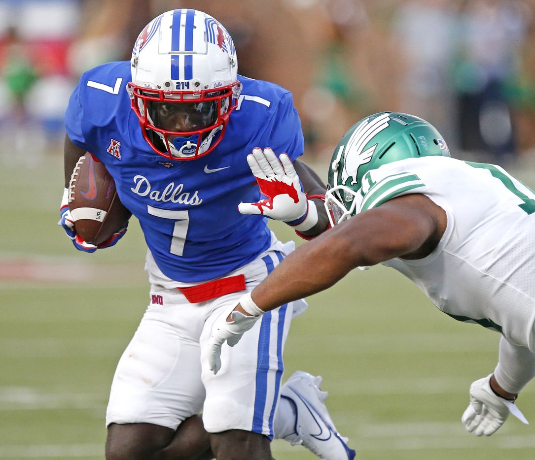 Southern Methodist Mustangs running back Ulysses Bentley IV (7) gives a stiff arm to North Texas Mean Green defensive end Gabriel Murphy (11) during the first half as SMU hosted UNT at Ford Stadium in Dallas on Saturday, September 11, 2021. (Stewart F. House/Special Contributor)