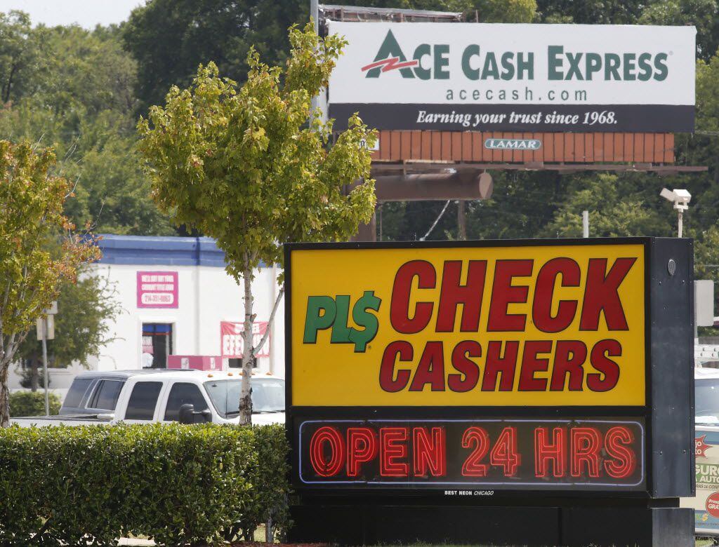 Ace Cash Express billboard looms in the background where many payday loans stores are...