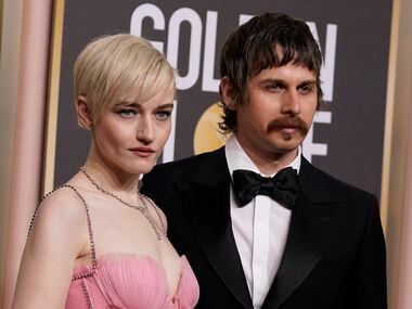 Julia Garner, left, and Mark Foster arrive at the 80th annual Golden Globe Awards at the...