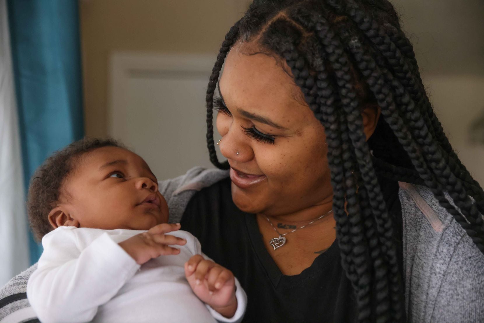 Roqueshea Lockett holds Ermias to pose for a portrait at her home in Dallas on Saturday, February 6, 2021. Lockett gave birth to her son two months ago at Lovers Lane Birth Center. (Lola Gomez/The Dallas Morning News)