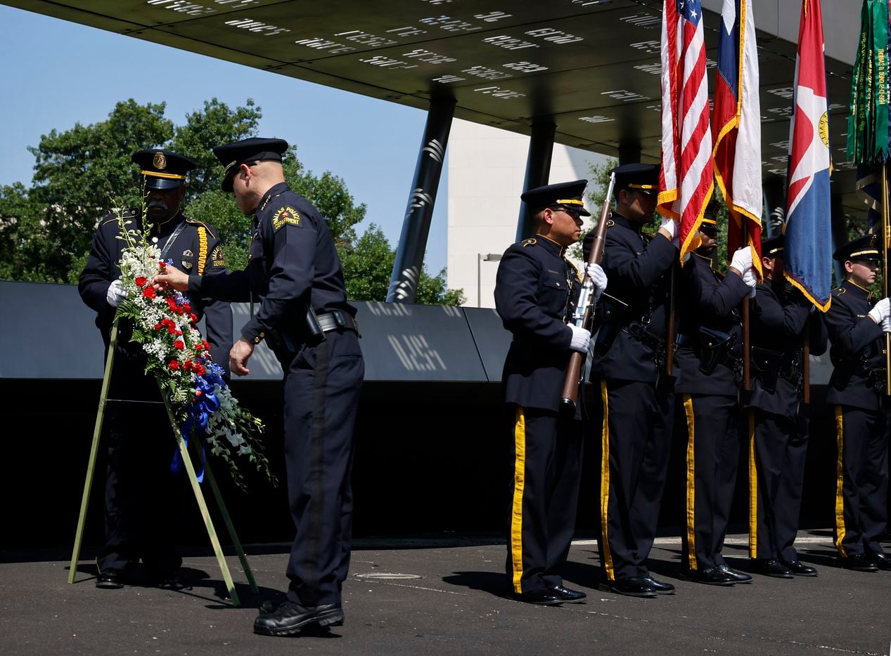 Dallas Police Chief Eddie Garcia places a missing flower back in a 7-7 wreath placed in honor of the officers who died in the line of duty on July 7th. It was the 5th anniversary of the ambush and special recognition was given to those officers who were killed during the 2021 Police Memorial Day at the Dallas Police Memorial in downtown Dallas, Wednesday, July 7, 2021. (Tom Fox/The Dallas Morning News)