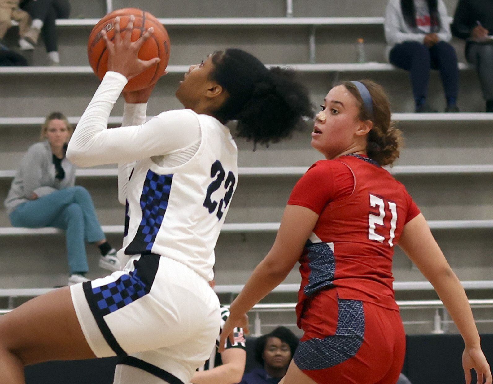 Hebron guard Paris Bradley (23), left, drives to the basket as she is defended by Denton...