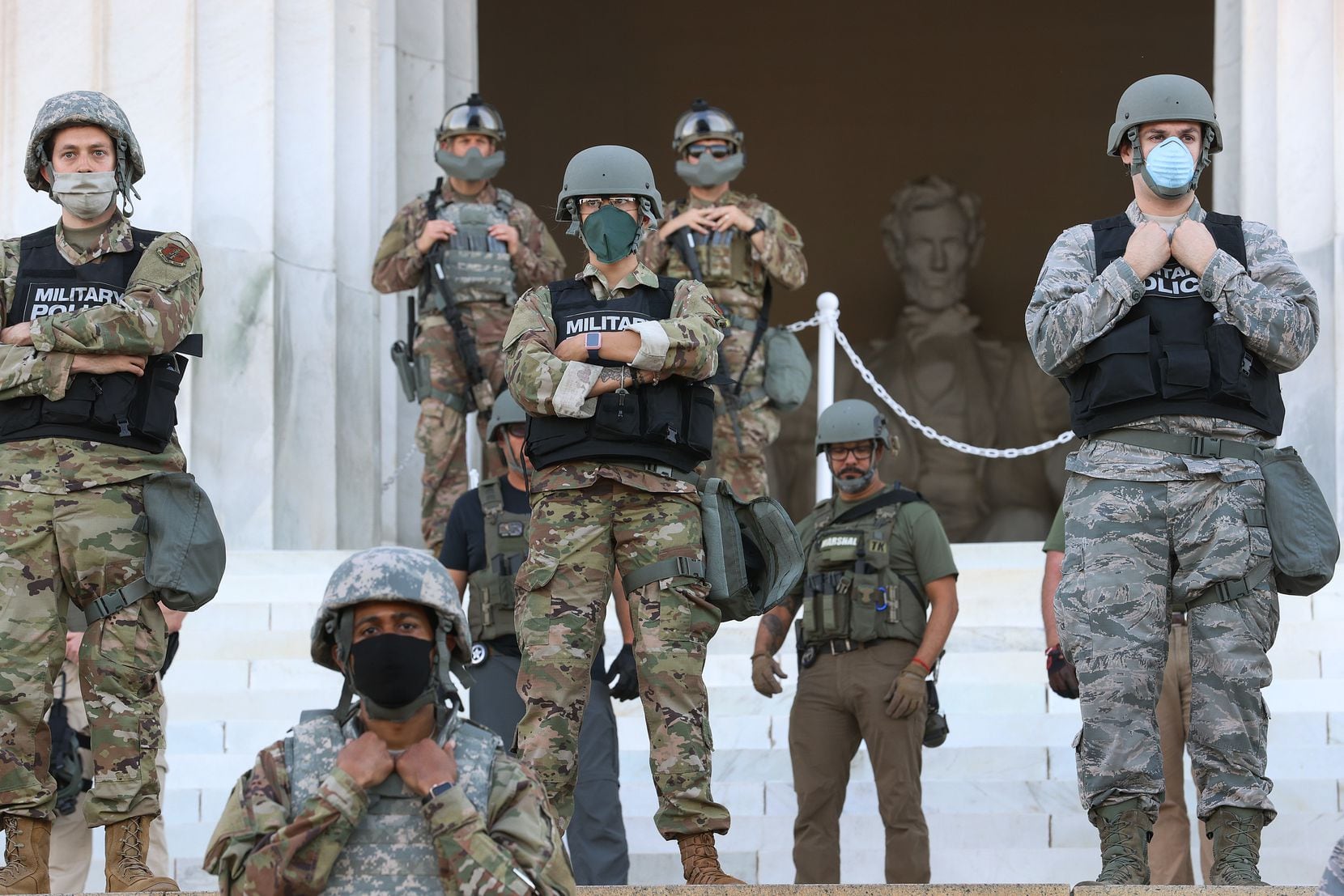 Members of the D.C. National Guard stand on the steps of the Lincoln Memorial monitoring a...