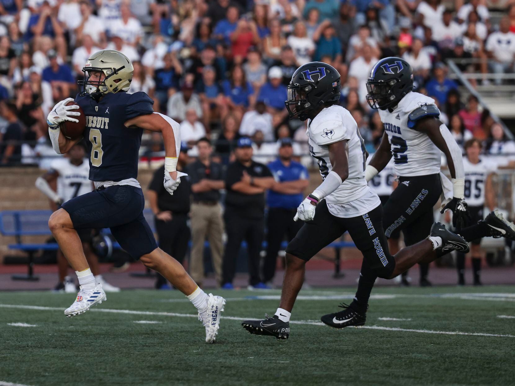 Jesuit Dallas Reed Pfaffenberger (8) runs the ball up the field as Hebron High School...