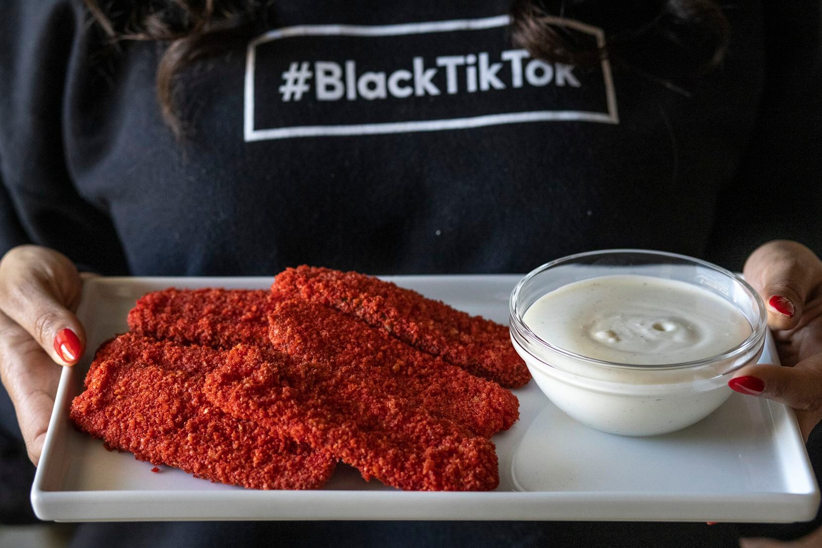 NaTasha Peck, creator of the YouTube channel ToshPointFro, poses for a portrait with Hot Cheetos fried pickles.
