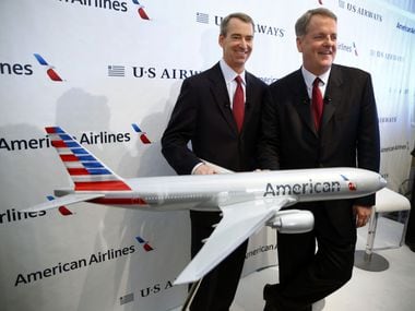 Tom Horton (left) and Doug Parker were all smiles when they announced the merger of American Airlines and US Airways in February 2013. But Parker had to overcome major opposition to his merger plan — from Horton and local politicians. Parker ultimately prevailed and became CEO of the combined companies. On Tuesday, Parker announced he will retire as American's CEO in March 2022.