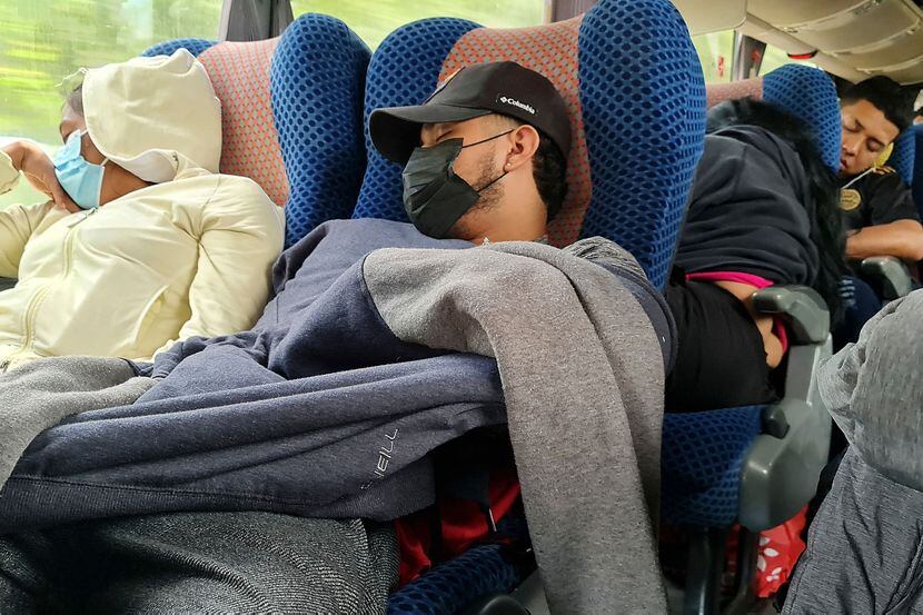 Migrants slept on board a bus during their travel between Nicaragua and Guatemala on...