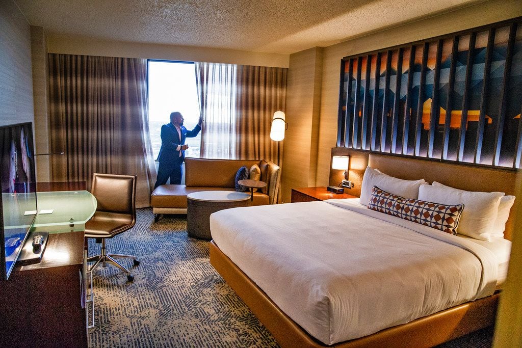 Chris Pilavakis, general manager of Renaissance Dallas hotel, opens window curtains in a...