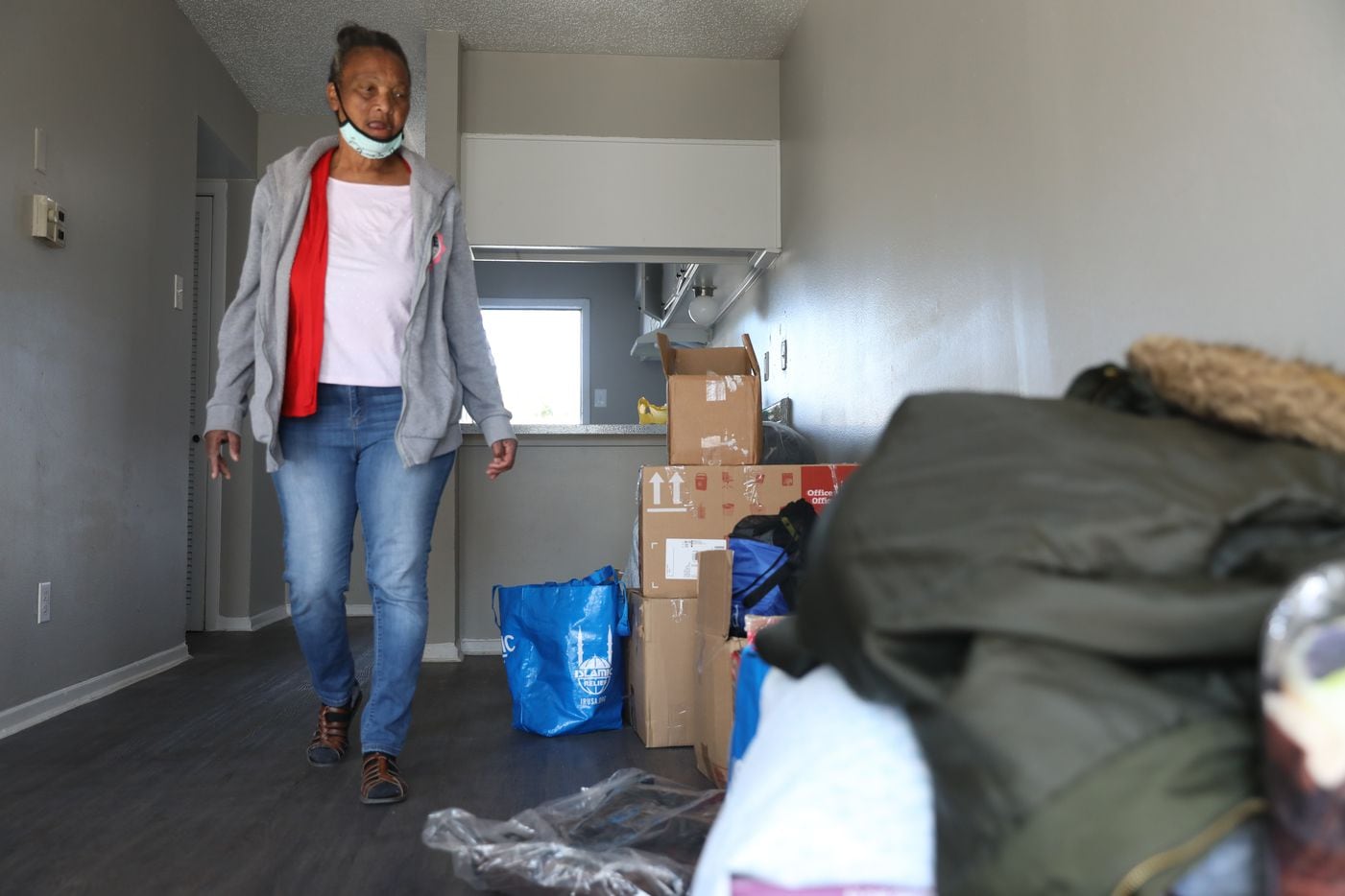Patricia Freeman walks up to the pile of her belongings to begin the process of unpacking her new apartment in southern Dallas on November 19, 2021. (Liesbeth Powers/Special Contributor)