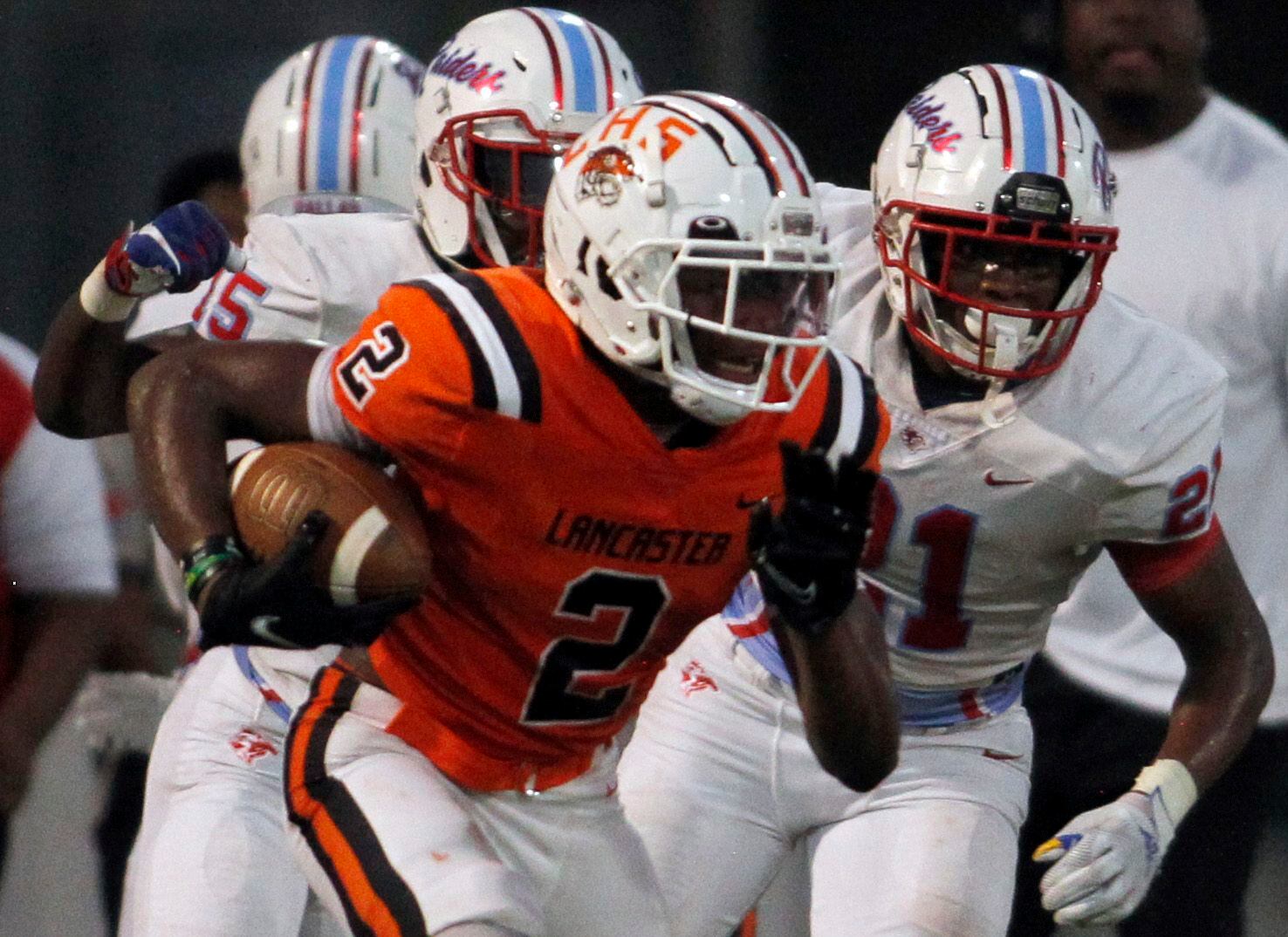 Lancaster running back Kewan Lacy (2) rushes as he is pursued by Dallas Skyline defenders...