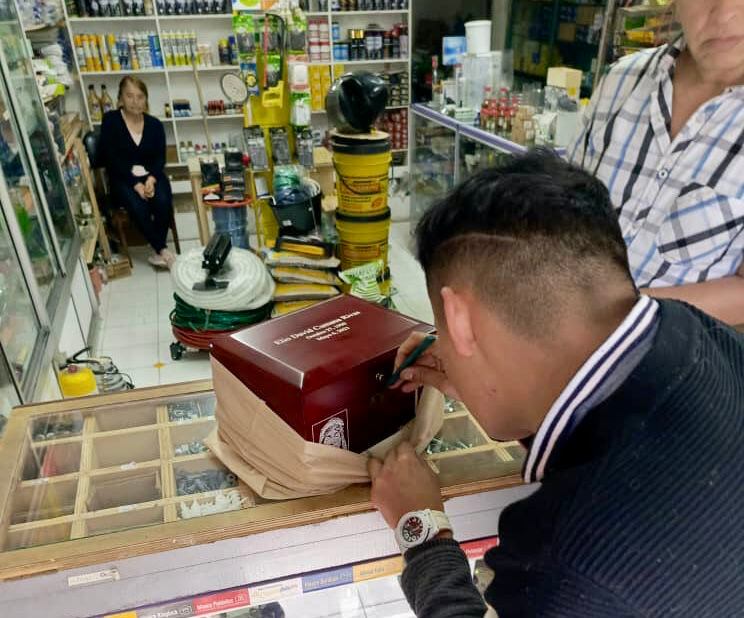 A man tries to open the urn with the ashes of Elio Cumana in a store in Bogotá, Colombia....