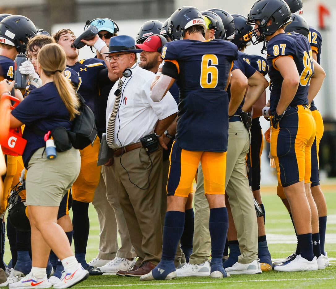 Highland Park coach Randy Allen talks to his team doing a timeout in the first quarter of...