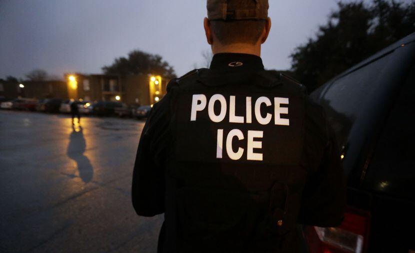 U.S. Immigration and Customs Enforcement agents enter an apartment complex in 2015 looking...