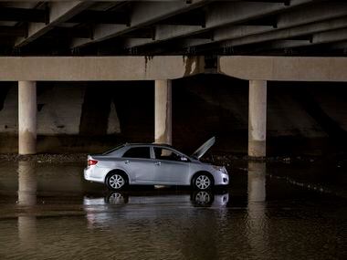 A driver sits in their stalled car on Military Parkway under Interstate 635 on Monday, Aug....
