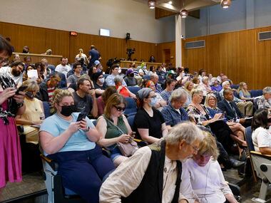 People fill the Denton City Council chambers during a meeting at Denton City Hall in Denton,...