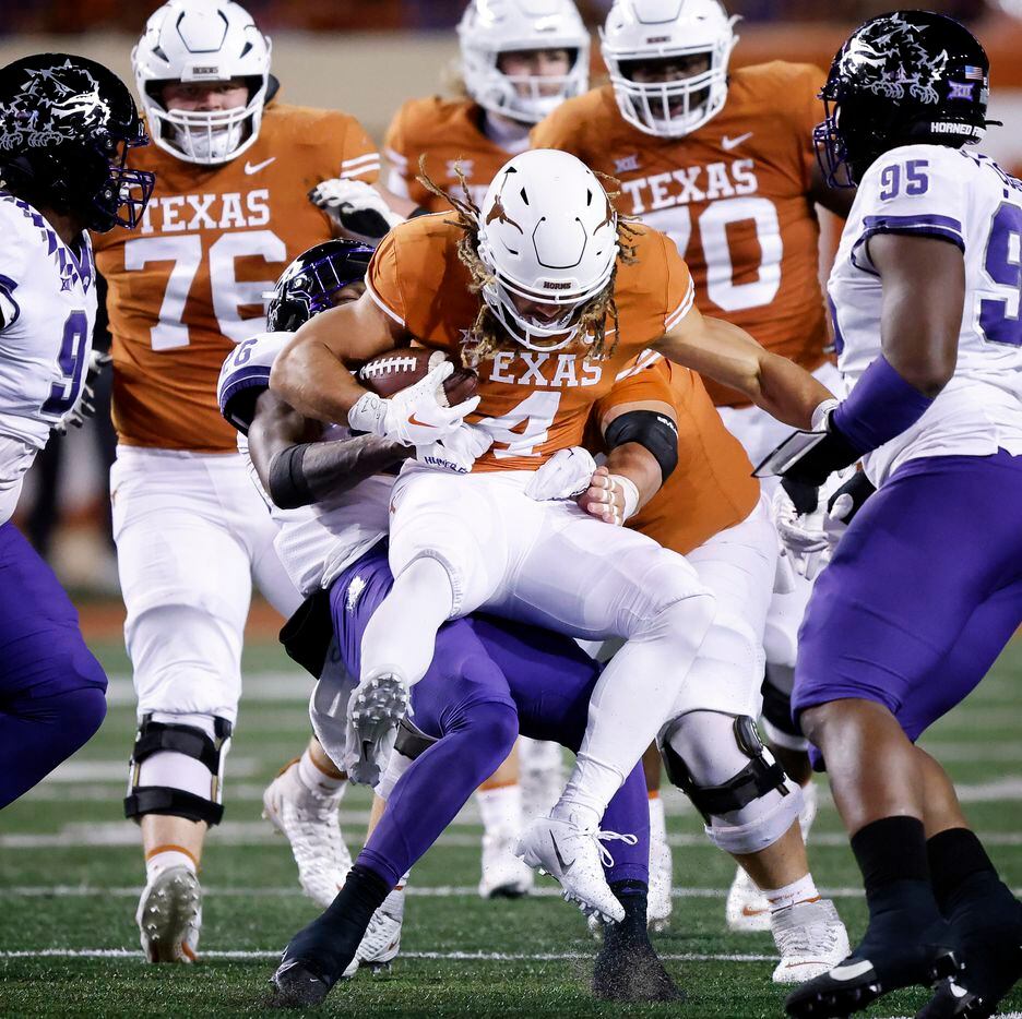 Texas Longhorns wide receiver Jordan Whittington (4) is lifted off his feet by TCU Horned...