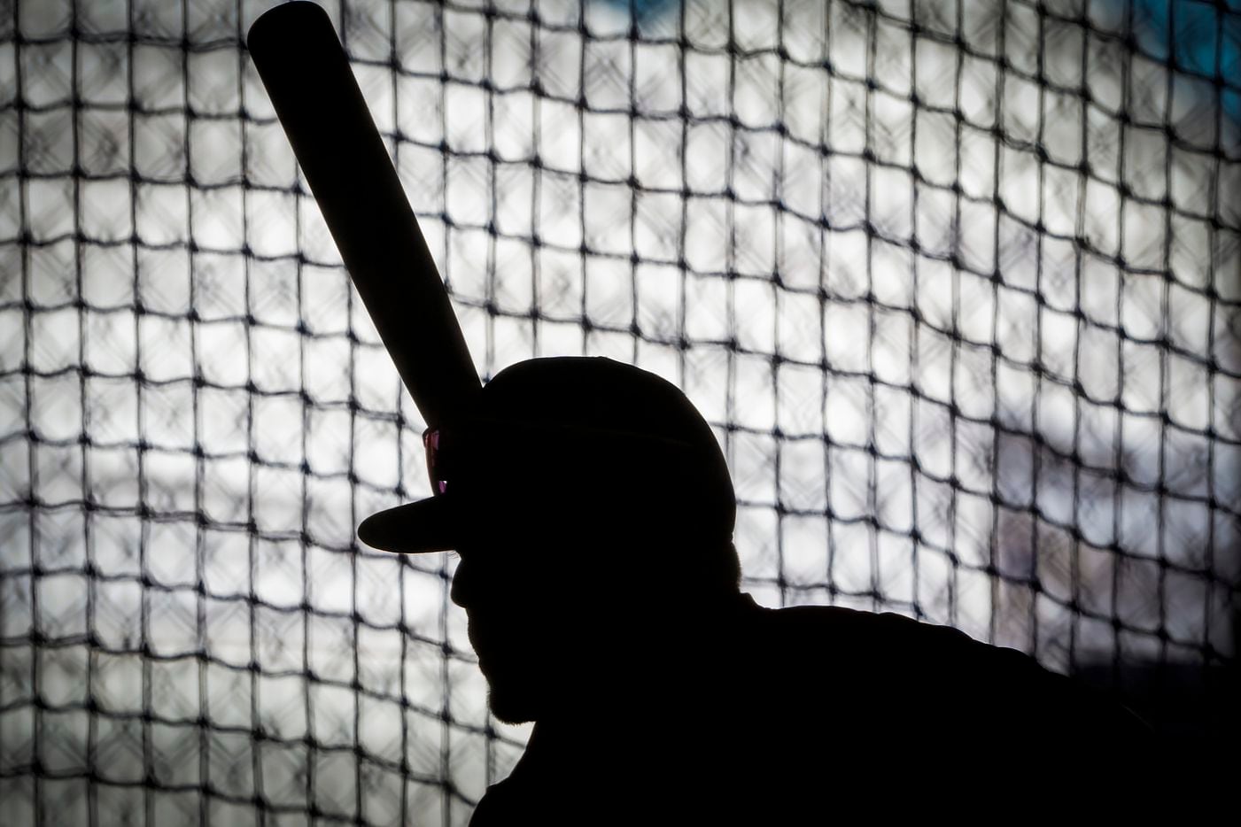 Texas Rangers infielder Blaine Crim takes a swing in the indoor batting cages during a...
