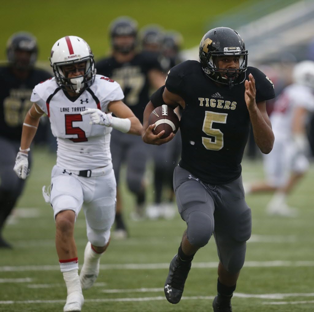 Mansfield Tigers Kennedy Brooks (5) escape from Lake Travis Cavaliers Robert Lee Rayos (5) ...