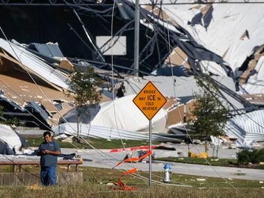 A collapsed building, damaged from a tornado the night before is seen near West Miller Road...