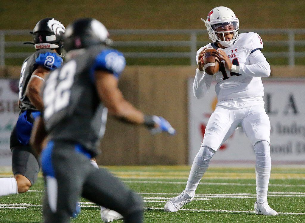 McKinney Boyd High School quarterback Carter Whitefield (14) looks to throw during the first...