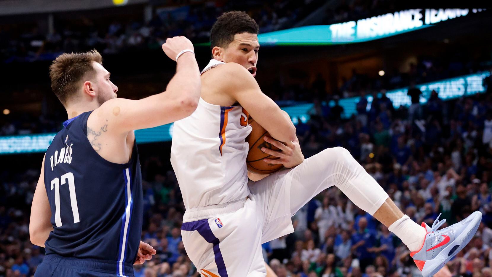Phoenix Suns guard Devin Booker (1) corrals a defensive rebound against Dallas Mavericks...
