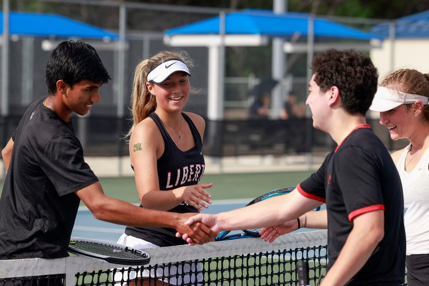 Frisco Liberty’s Sanjheev Rao (left) and teammate Milla Dopson (second from left) shake...