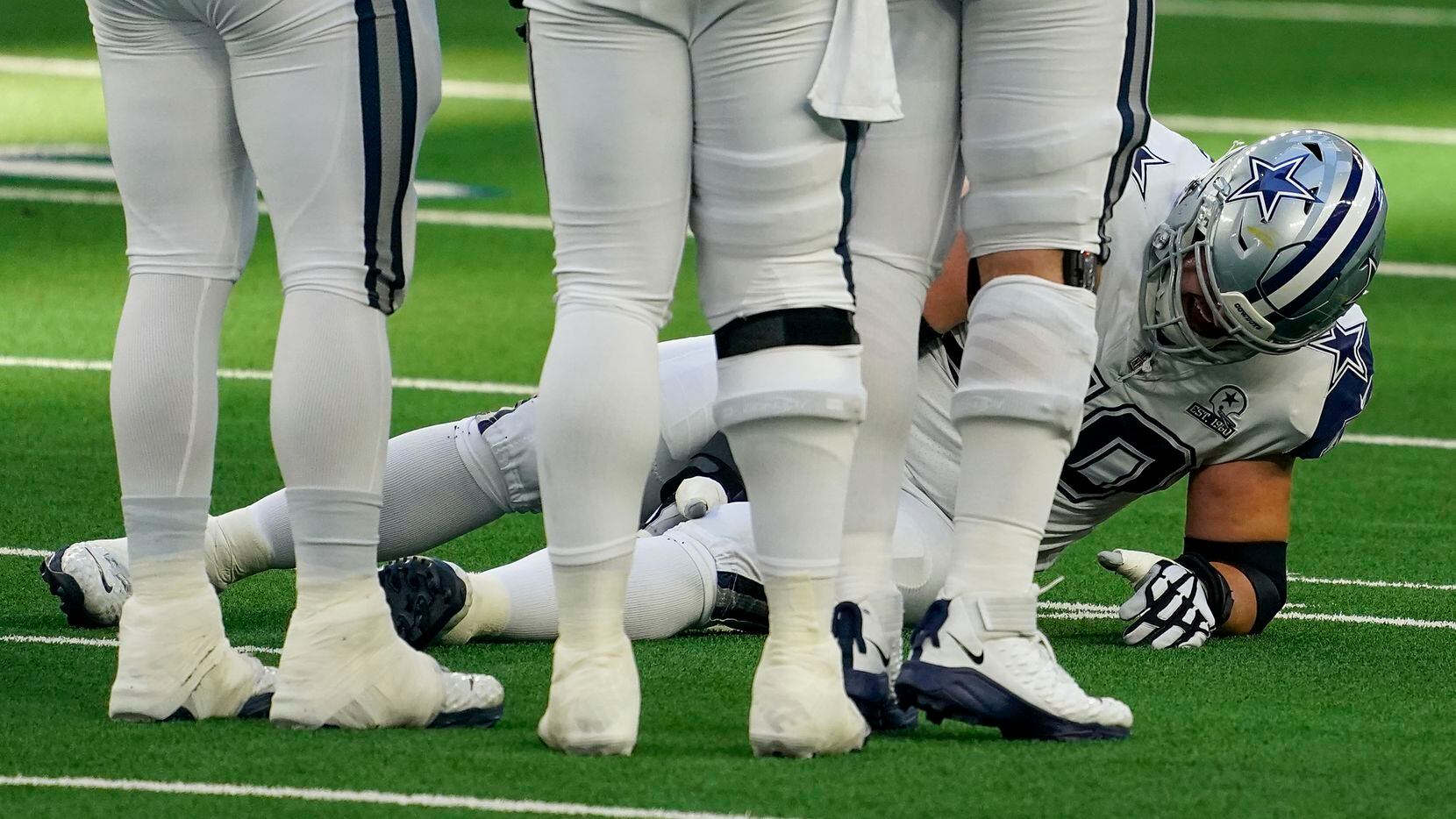 El guardia ofensivo Zack Martin cae al piso luego de lesionarse en el partido de los Cowboys...