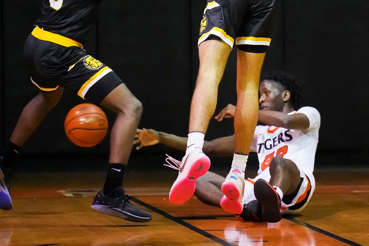 Lancaster's Jordan Williams (22) controls a loose ball during a boys high school basketball...