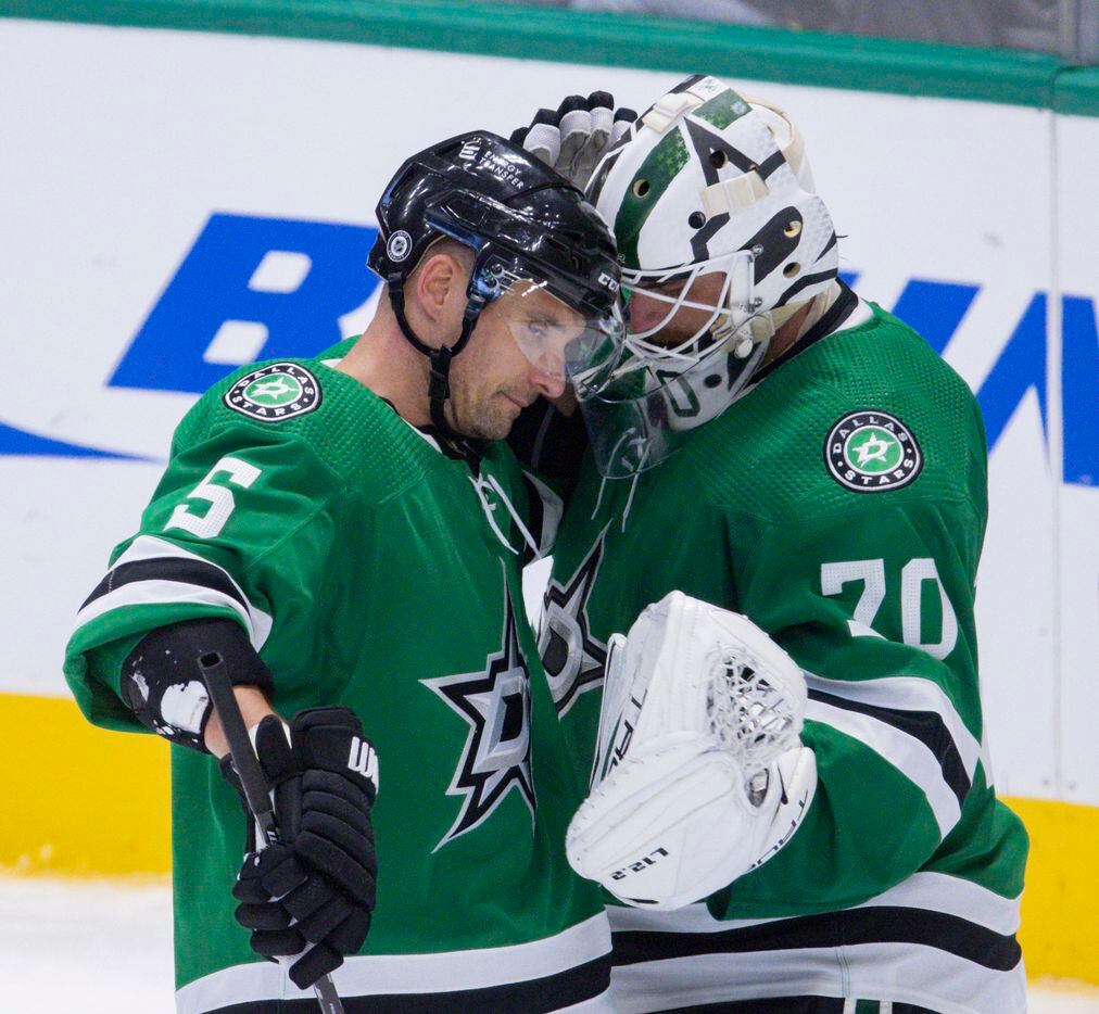 Dallas Stars defenseman Andrej Sekera (5) celebrates with Dallas Stars goaltender Braden Holtby (70) their preseason game win against St. Louis Blues on Tuesday, Oct. 5, 2021, at American Airlines Center in Dallas. (Juan Figueroa/The Dallas Morning News)