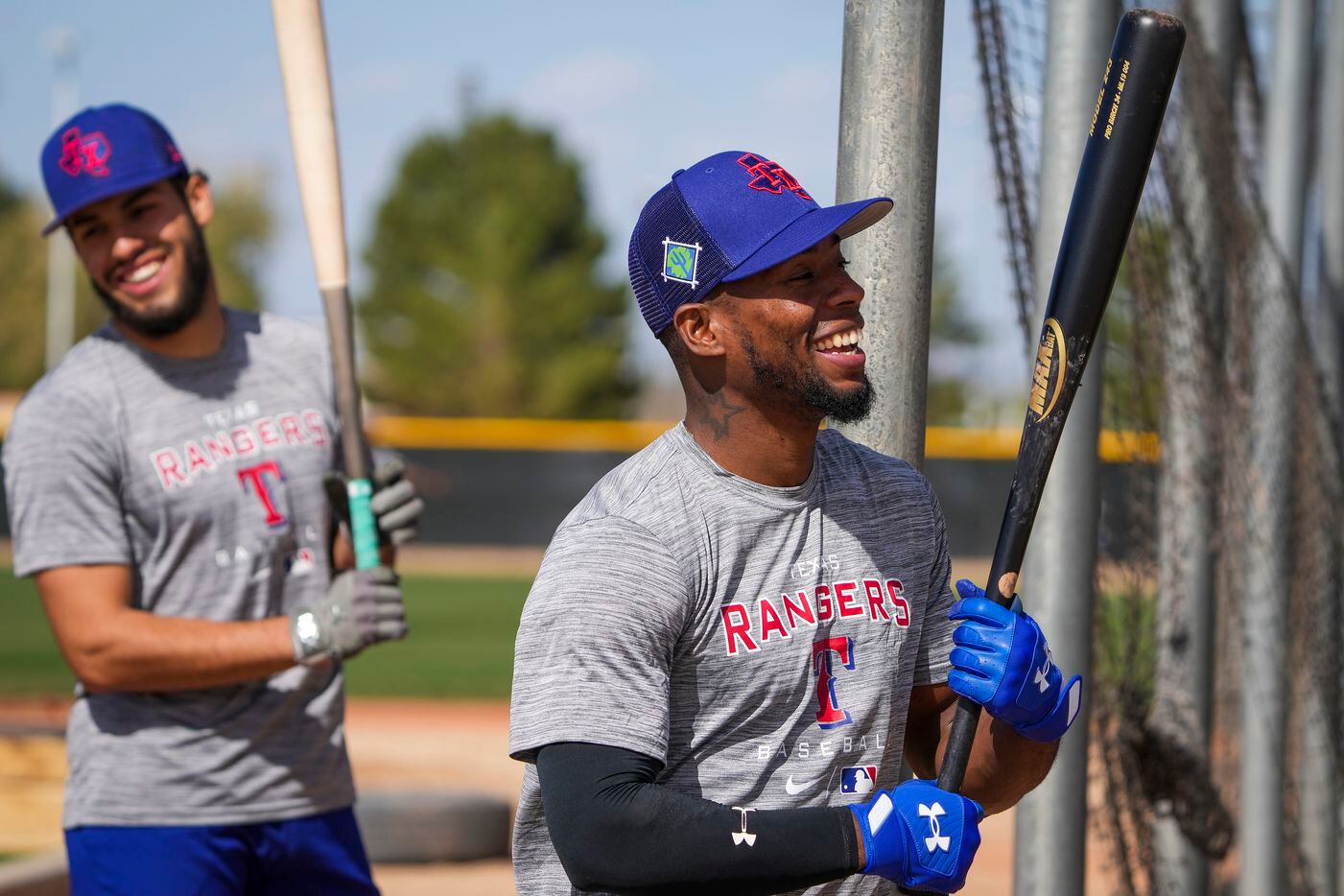 Texas Rangers minor league outfielder J.P. Martinez (right) smiles as he steps into the...