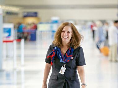 American Airlines Flight Attendant Diane Huisenga, wearing one of the airline's new...