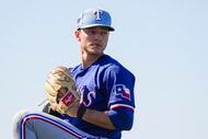 Texas Rangers pitcher Jack Leiter throws in the outfield during a spring training workout at...