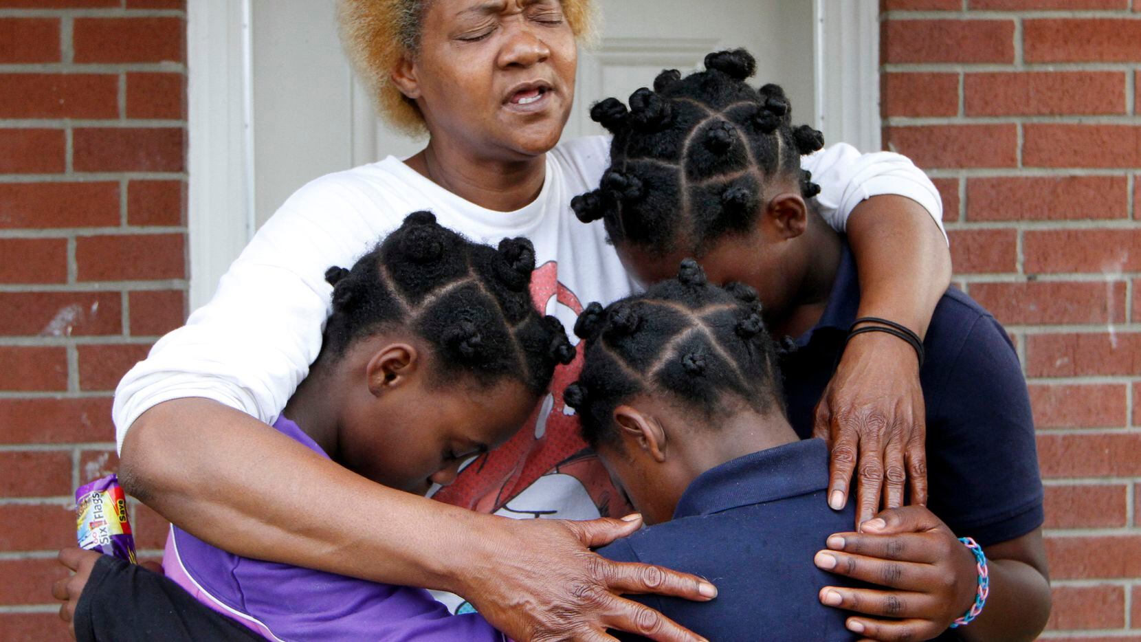 Paula Wooten prays with her grandchildren, A'avryanna Wooten, 10 (left);  I'ivryanna Wooten,...