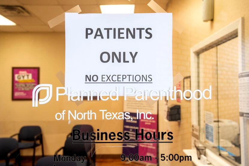 A sign on the door of Planned Parenthood prohibits entry by  everyone but patients to limit...