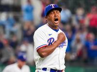 Texas Rangers relief pitcher Jose Leclerc reacts after striking out Philadelphia Phillies...