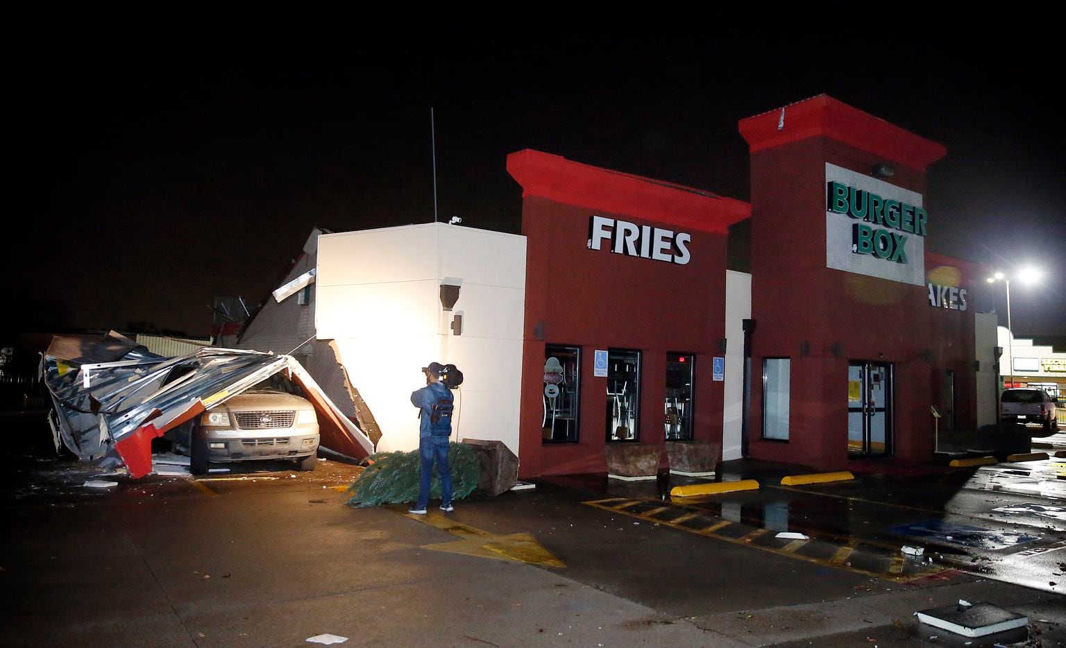 The roof of the drive-thru at the Burger Box restaurant on Cooper St. in Arlington trapped drivers when a tornado-warned storm blew through, Tuesday night, November 24, 2020. No one was seriously injured.