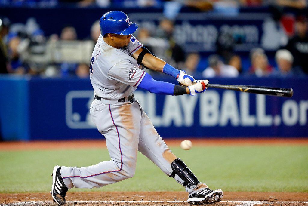Texas Rangers left fielder Carlos Gomez (14) swings and misses on a low pitch against...