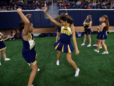 Highland Park cheerleaders Sarah Klein, right, and Brielle Robertson, left, dance before the...