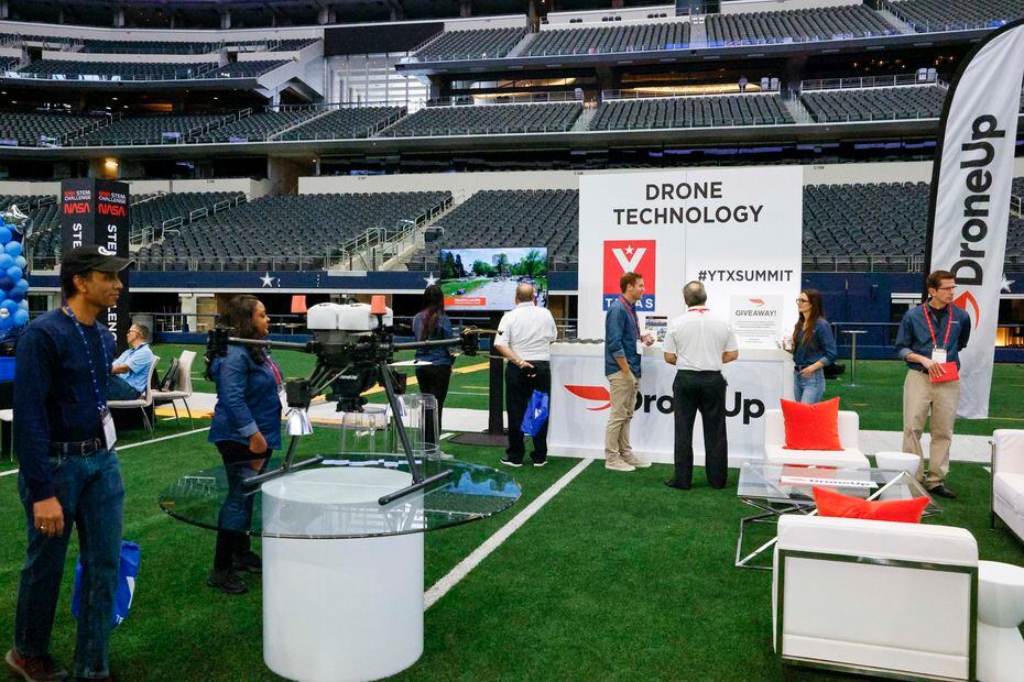 Attendees visit a drone technology exhibit during the 2022 YTexas Summit at AT&T Stadium in...